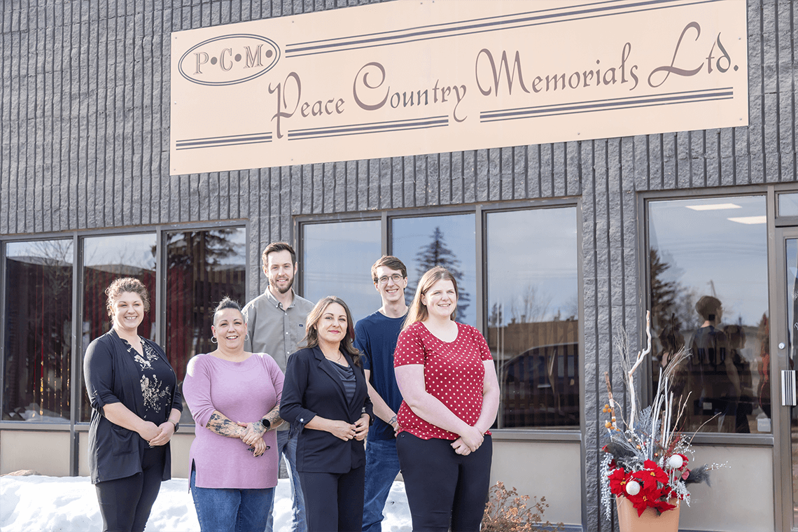 The Peace Country Memorials team standing in front of the PC Memorials building.